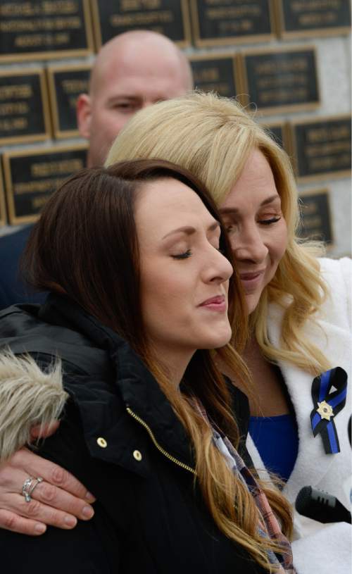 Francisco Kjolseth | The Salt Lake Tribune
Widows of Utah's fallen officers, Shante Johnson, front, is embraced by Nannette Wride, during a press event at the Utah Law Enforcement Memorial at the Capitol as the Utah legislature prepares to pass the first major reform to line-of-duty death benefits for police officers and their surviving family.